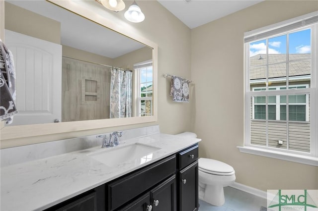 bathroom with tile patterned flooring, vanity, toilet, and walk in shower