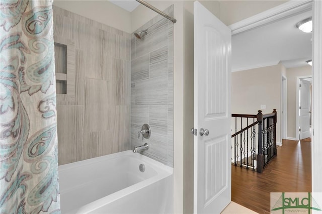 bathroom featuring wood-type flooring and shower / bath combination with curtain