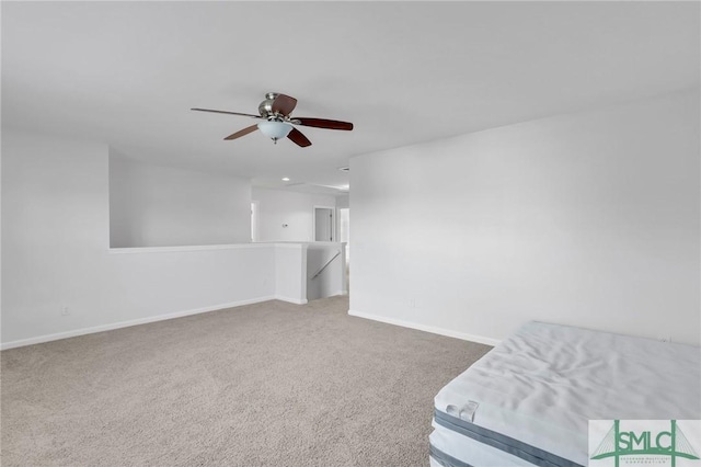 interior space with carpet flooring and ceiling fan