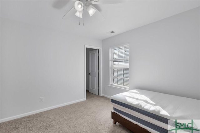 bedroom with ceiling fan and light carpet