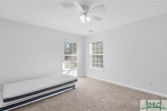 unfurnished bedroom featuring carpet and ceiling fan