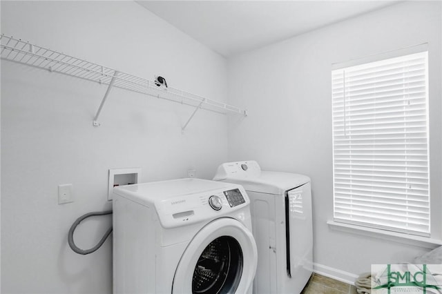 clothes washing area featuring independent washer and dryer