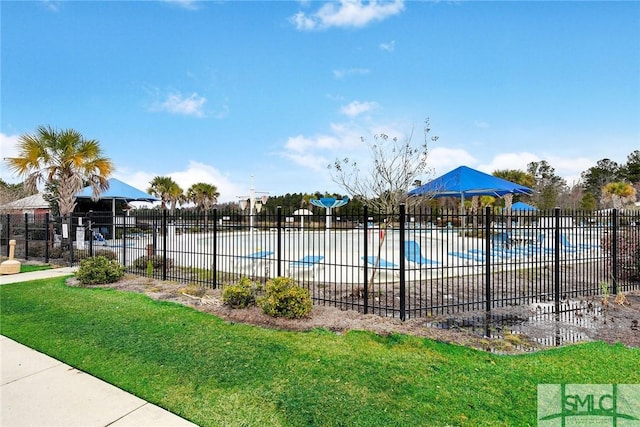 view of pool featuring a yard