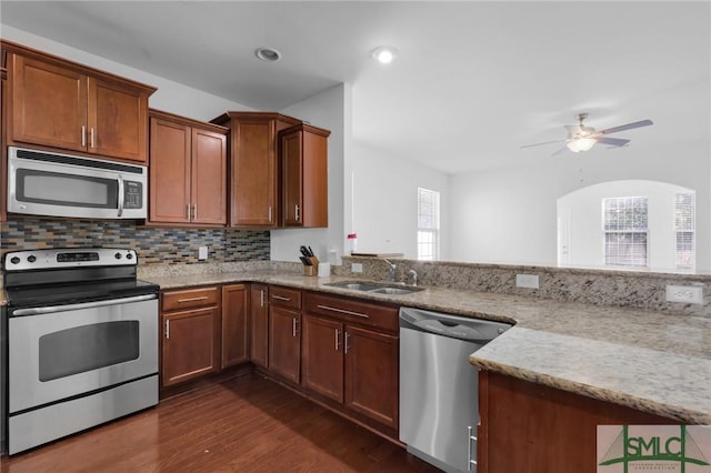 kitchen with a healthy amount of sunlight, sink, stainless steel appliances, and dark wood-type flooring