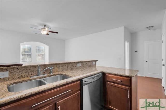 kitchen featuring dishwasher, light stone counters, ceiling fan, and sink