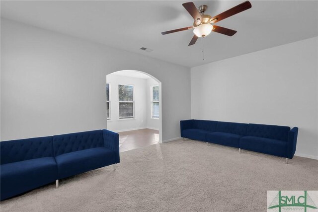 living room featuring ceiling fan and carpet