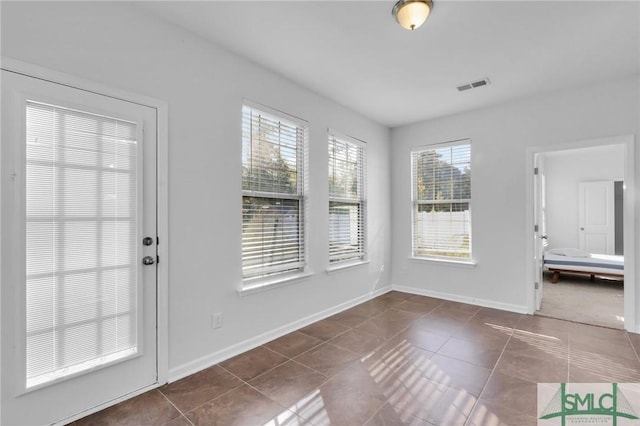 interior space featuring dark tile patterned flooring