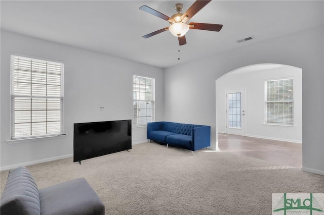 carpeted living room with ceiling fan