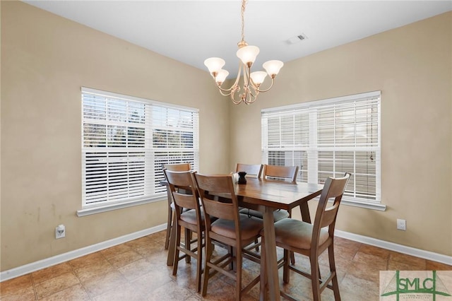 dining area with an inviting chandelier