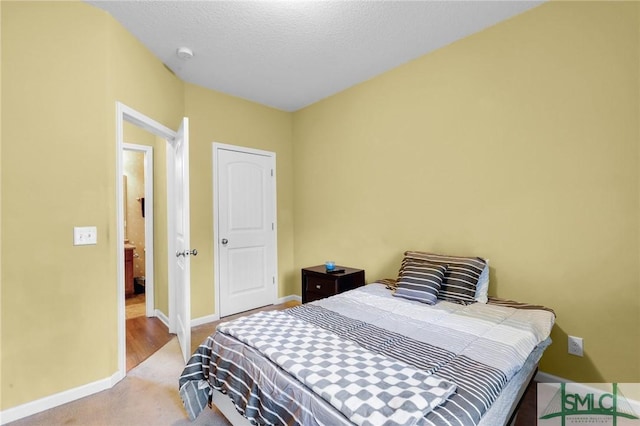 carpeted bedroom featuring a textured ceiling