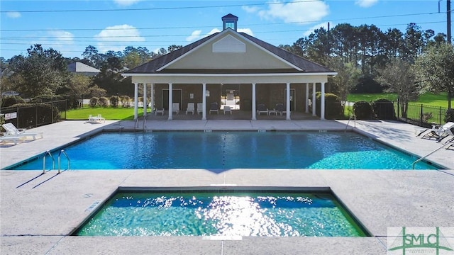 view of pool with a patio area and a hot tub