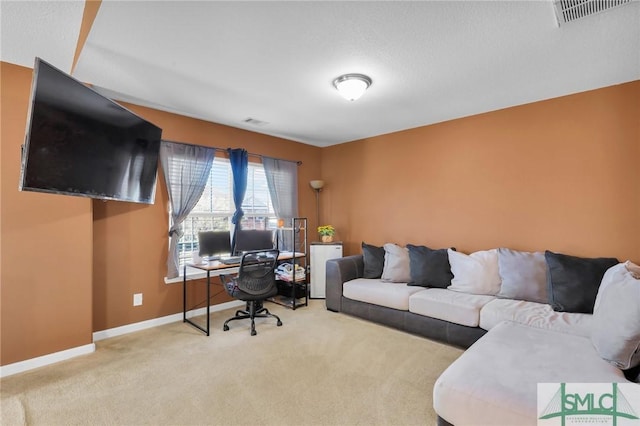 carpeted office featuring a textured ceiling