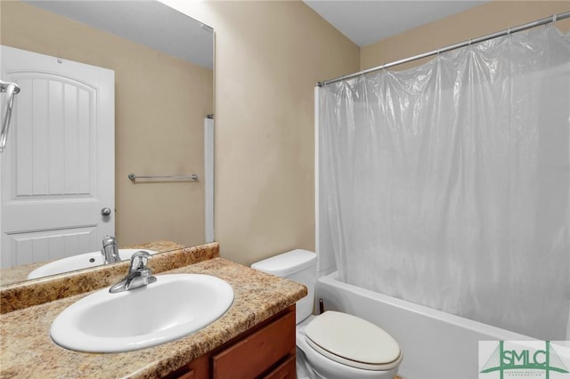 full bathroom featuring shower / bath combo, vanity, and toilet