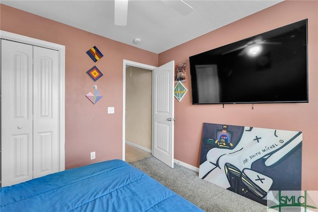 bedroom with ceiling fan, a closet, and carpet floors