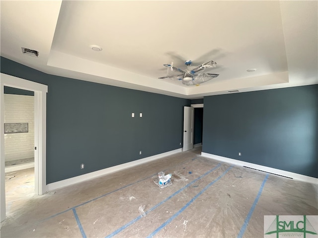 unfurnished bedroom featuring a raised ceiling