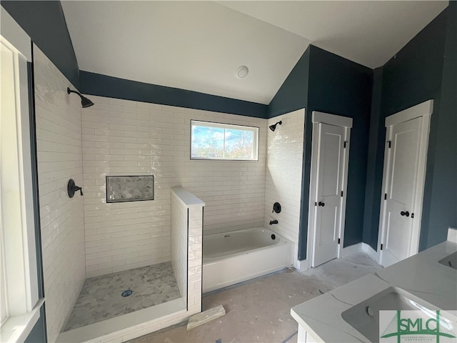 bathroom featuring vanity, shower with separate bathtub, and vaulted ceiling