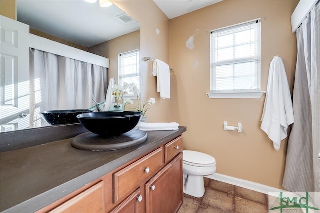 bathroom featuring vanity and toilet