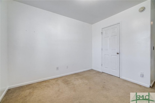 spare room with light carpet