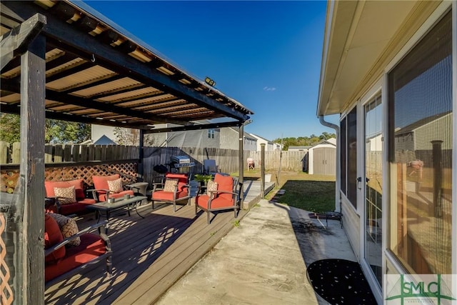 wooden deck featuring outdoor lounge area and a storage shed