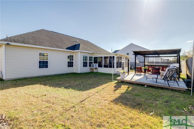 back of house featuring a lawn, a sunroom, a pergola, a wooden deck, and cooling unit