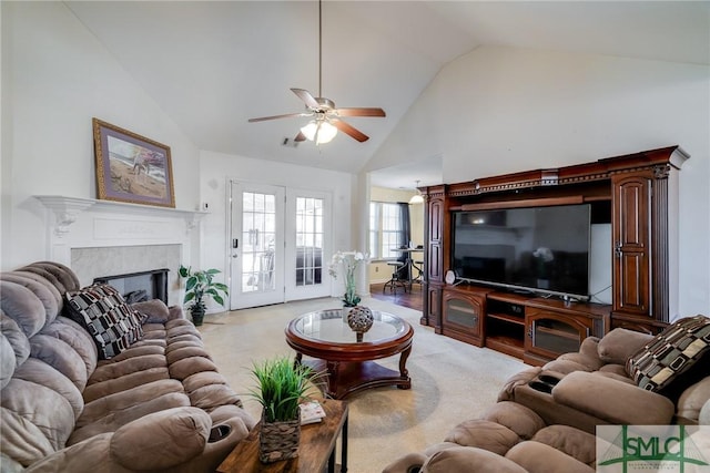 living room featuring ceiling fan and high vaulted ceiling