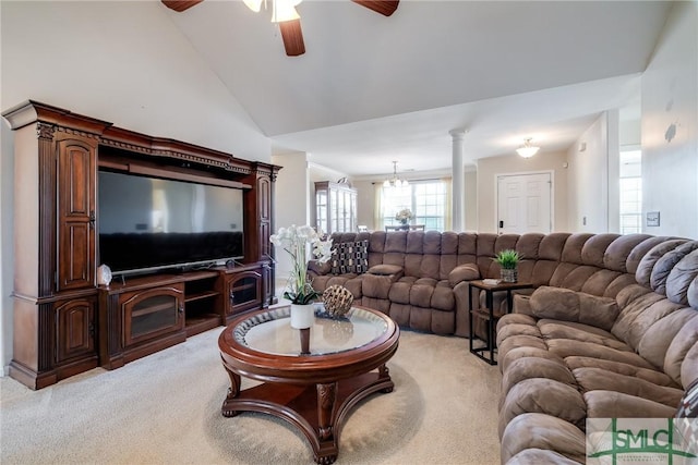 carpeted living room featuring ceiling fan with notable chandelier, lofted ceiling, and ornate columns