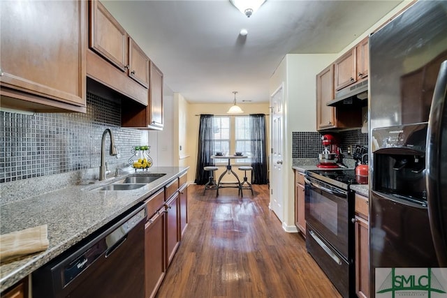 kitchen featuring dark hardwood / wood-style flooring, tasteful backsplash, sink, black appliances, and decorative light fixtures