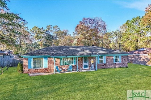 view of front facade featuring a front yard and a patio