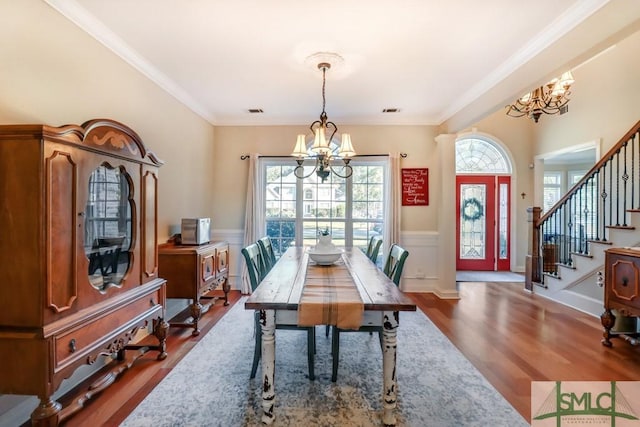 dining room featuring a notable chandelier, crown molding, and wood-type flooring