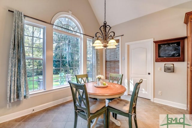 dining space featuring an inviting chandelier, tile patterned flooring, and vaulted ceiling