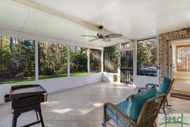 sunroom / solarium featuring ceiling fan