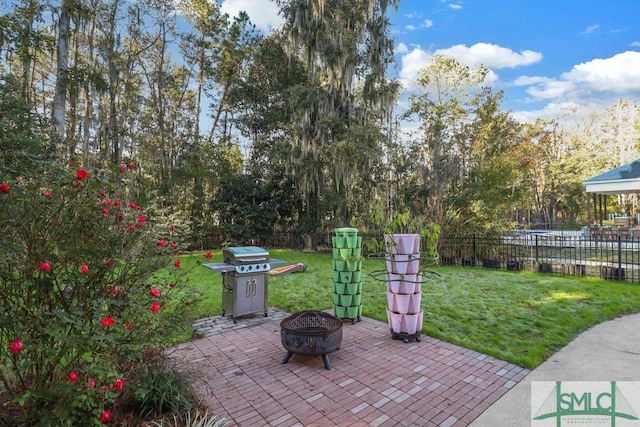 view of patio / terrace featuring grilling area and a fire pit