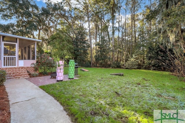 view of yard featuring a patio area and a sunroom