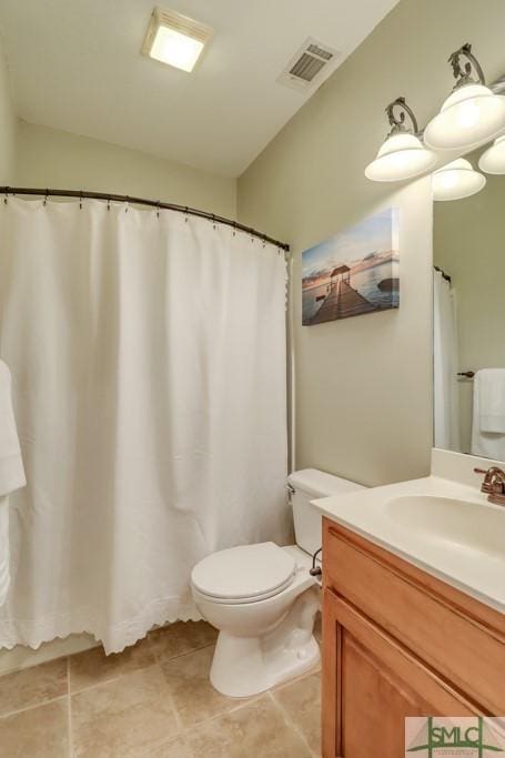 bathroom with tile patterned flooring, vanity, and toilet