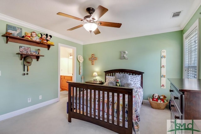 bedroom featuring ceiling fan, light colored carpet, ornamental molding, and connected bathroom