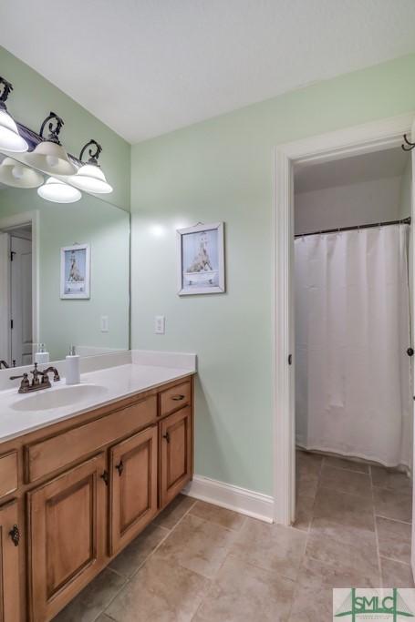 bathroom with vanity and tile patterned flooring