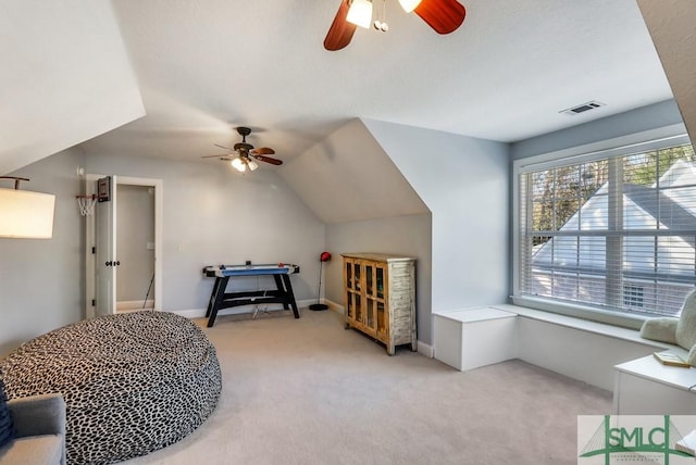 carpeted bedroom featuring ceiling fan and vaulted ceiling