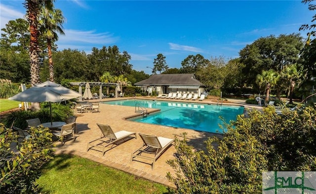 view of pool with a patio and a pergola