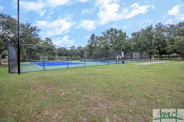 exterior space featuring a lawn and tennis court