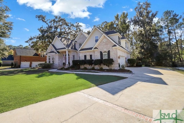 view of front of house featuring a garage and a front lawn