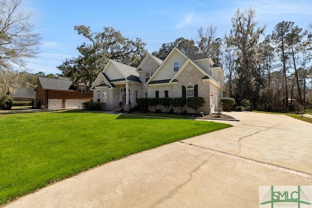 view of front of house featuring brick siding, a garage, driveway, and a front lawn