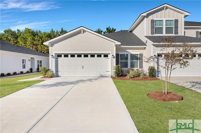 view of front of property with a front yard and a garage