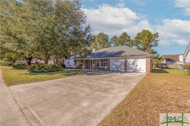 view of front of home with a front lawn and a garage