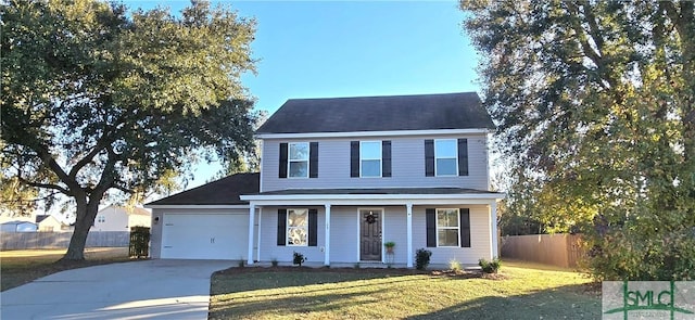 view of front of home with a front yard and a garage