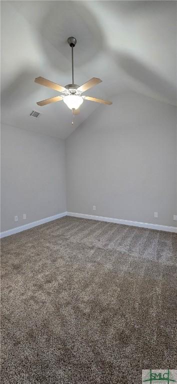 unfurnished room featuring carpet and vaulted ceiling