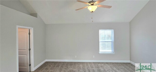 carpeted empty room featuring ceiling fan and vaulted ceiling