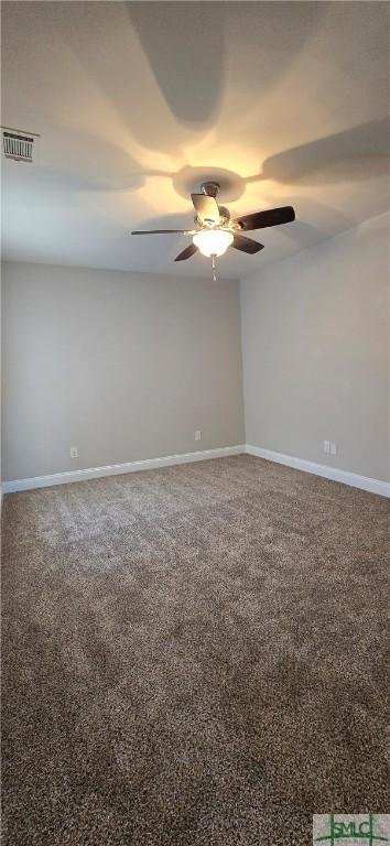 spare room with carpet flooring and ceiling fan