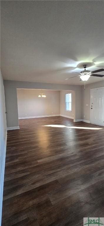 spare room with ceiling fan and dark wood-type flooring