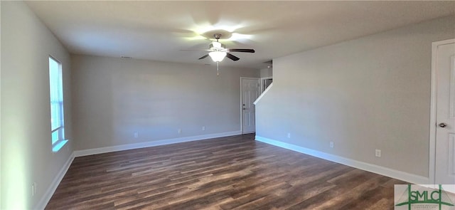 spare room featuring ceiling fan and dark wood-type flooring