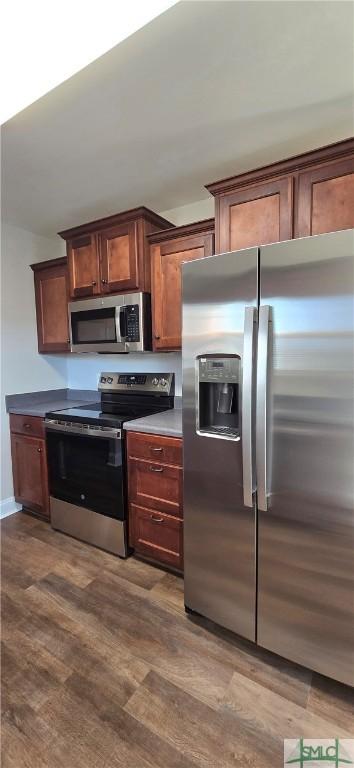 kitchen with hardwood / wood-style floors and appliances with stainless steel finishes